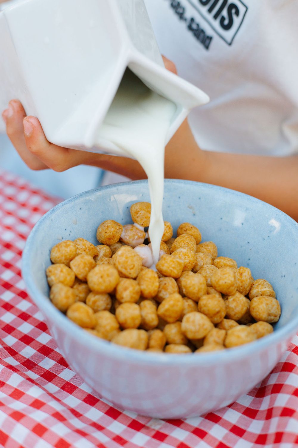 Close-up of milk being poured over a bowl of Cheeky Pete's cereal