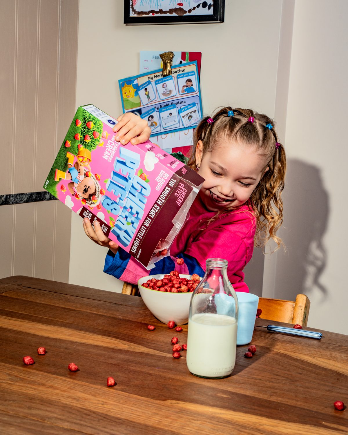 Child happily pouring Cheeky Pete's into a bowl
