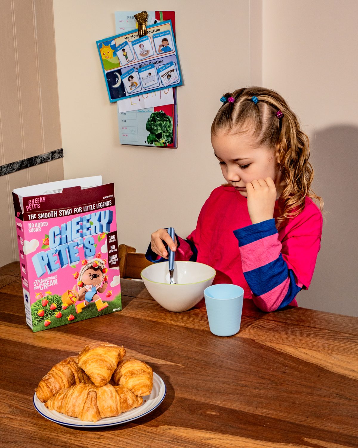 Child playfully tossing a piece of cereal into the air